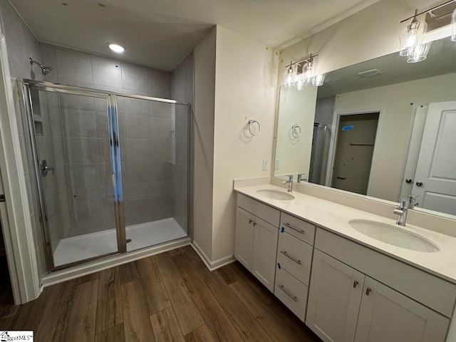 bathroom featuring hardwood / wood-style floors, vanity, and an enclosed shower