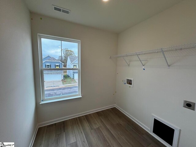 laundry area featuring hookup for an electric dryer, hookup for a washing machine, and dark hardwood / wood-style floors