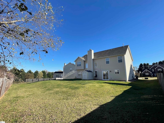 rear view of property with a lawn