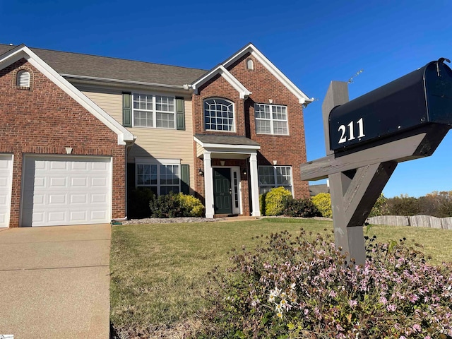 view of front of home with a front lawn and a garage