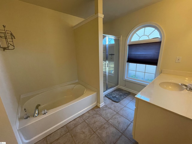 bathroom with plus walk in shower, tile patterned flooring, and vanity