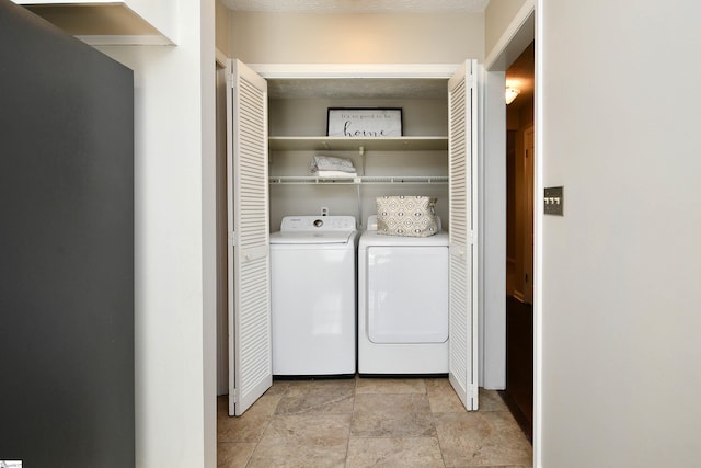 laundry area featuring washer and dryer and a textured ceiling