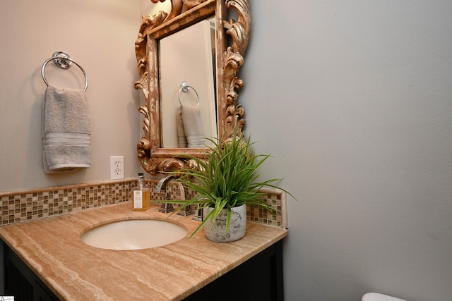 bathroom featuring vanity and tasteful backsplash