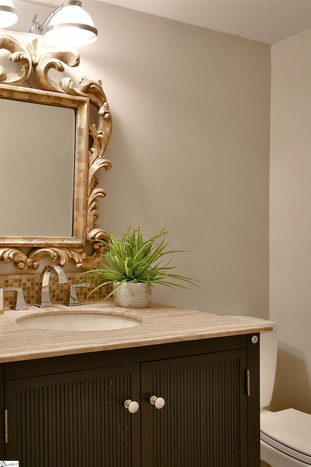 bathroom featuring vanity and toilet