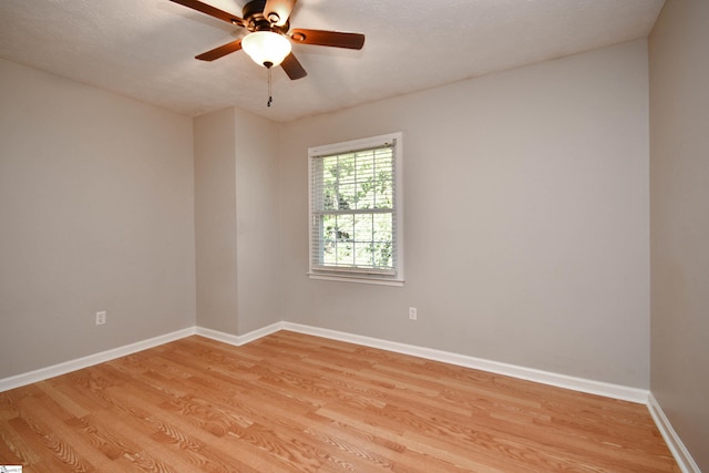 unfurnished room with ceiling fan, light hardwood / wood-style flooring, and a textured ceiling