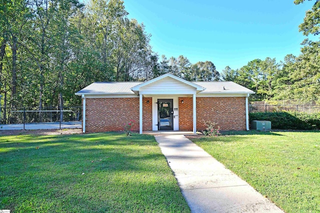 single story home featuring a front yard and covered porch