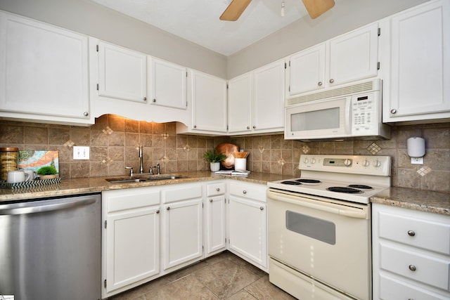 kitchen with decorative backsplash, white cabinetry, sink, and white appliances