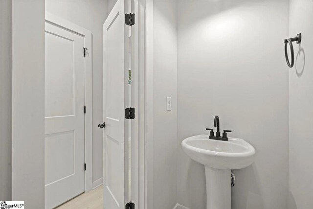 bathroom with wood-type flooring and sink