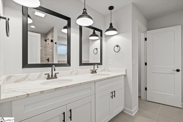 bathroom with tiled shower, vanity, and tile patterned floors