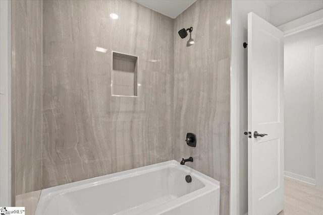 bathroom featuring hardwood / wood-style flooring and tiled shower / bath