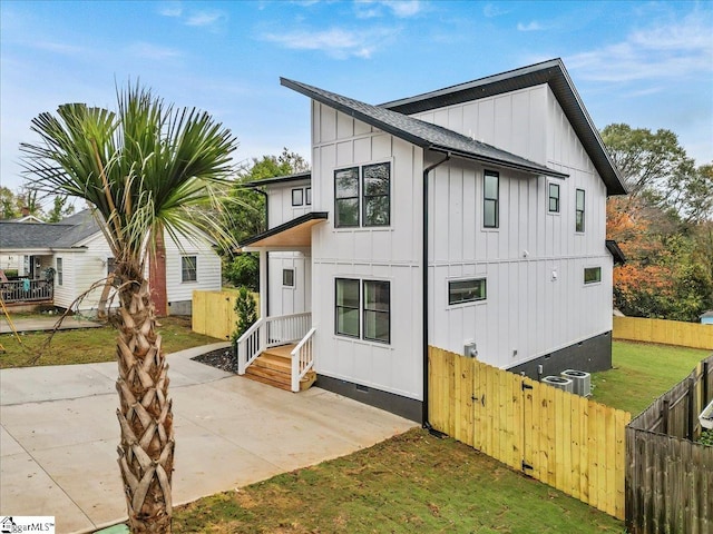 view of front of house featuring central AC and a patio area