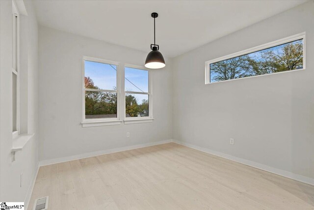 empty room with light hardwood / wood-style floors