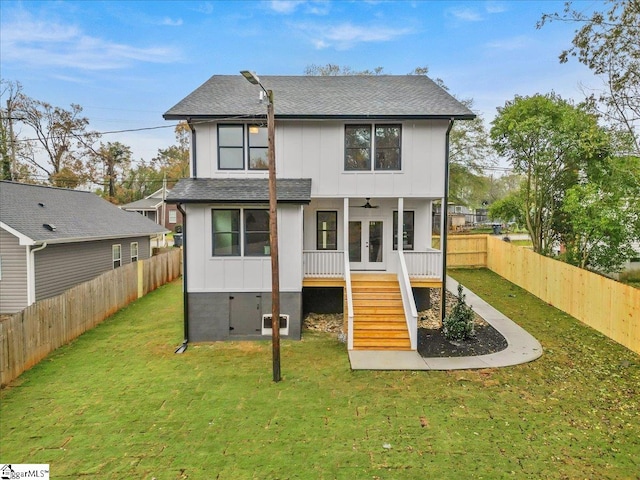 back of house with french doors, ceiling fan, and a lawn