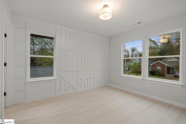 spare room with plenty of natural light and light wood-type flooring