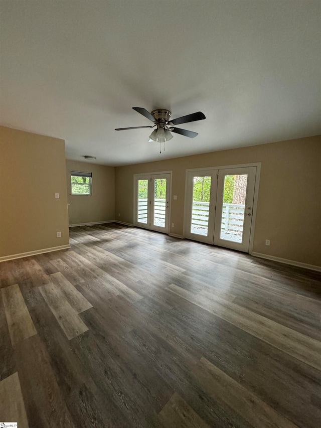 unfurnished room with ceiling fan, dark wood-type flooring, and french doors