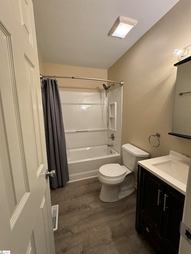 full bathroom featuring vanity, toilet, wood-type flooring, and shower / tub combo with curtain