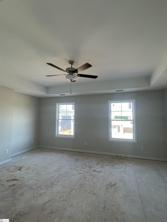 unfurnished room with ceiling fan and a healthy amount of sunlight