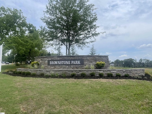 community / neighborhood sign featuring a yard