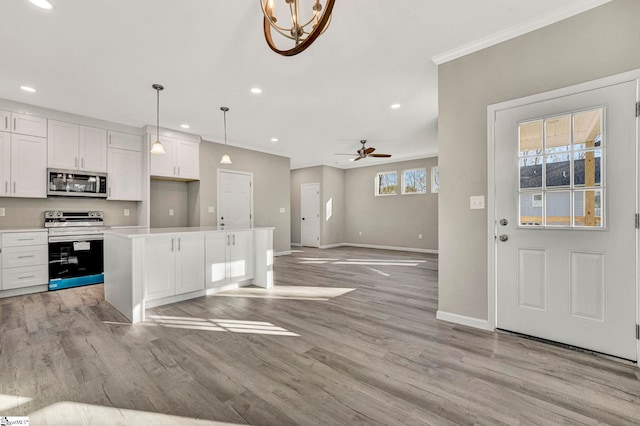 kitchen featuring pendant lighting, ceiling fan, white cabinetry, and appliances with stainless steel finishes