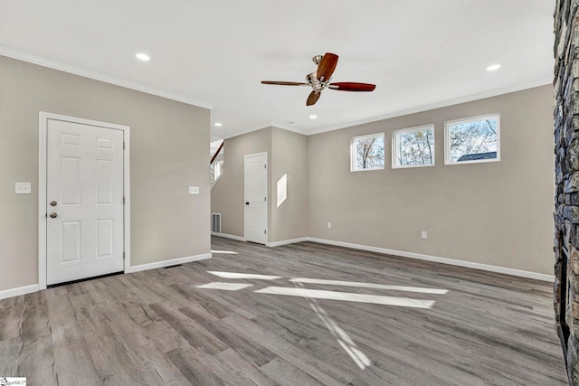 unfurnished living room with light hardwood / wood-style floors, ceiling fan, and crown molding