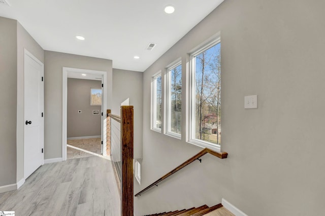 corridor with light hardwood / wood-style flooring