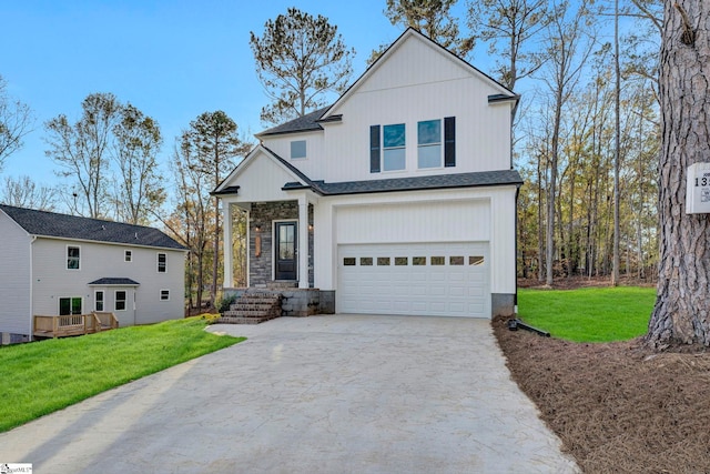 view of front of house featuring a garage and a front lawn