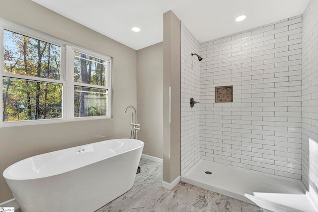 bathroom with separate shower and tub