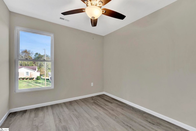 empty room with light hardwood / wood-style flooring and ceiling fan