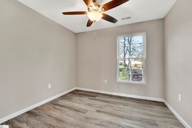 empty room featuring ceiling fan and light hardwood / wood-style floors