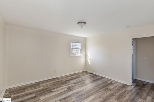 unfurnished room featuring hardwood / wood-style flooring