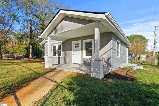 bungalow-style house featuring a porch and a front lawn