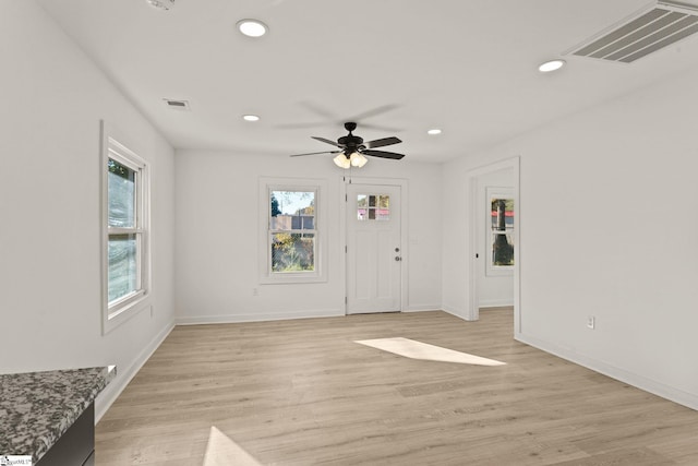 interior space with ceiling fan and light hardwood / wood-style floors