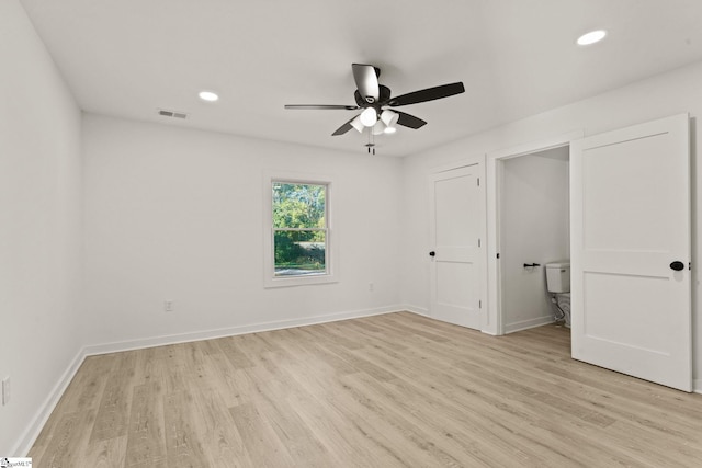 unfurnished bedroom with connected bathroom, ceiling fan, and light hardwood / wood-style flooring