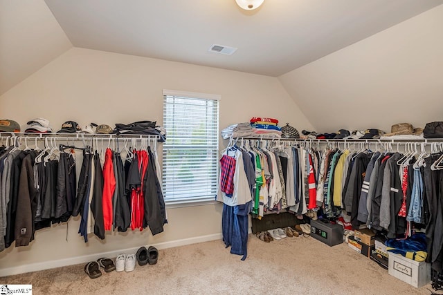 spacious closet with vaulted ceiling and carpet flooring