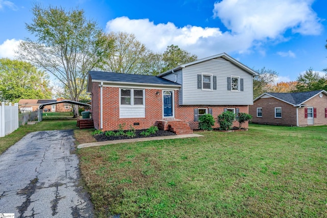 tri-level home with a front lawn and a carport