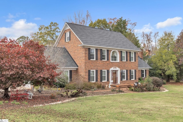 colonial inspired home with a front yard