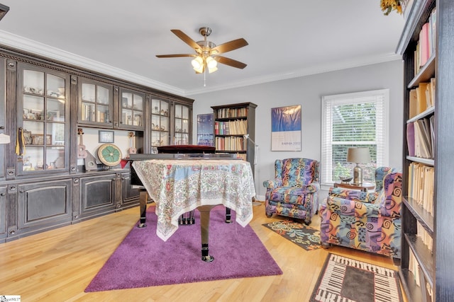 recreation room featuring ceiling fan, light hardwood / wood-style floors, and ornamental molding