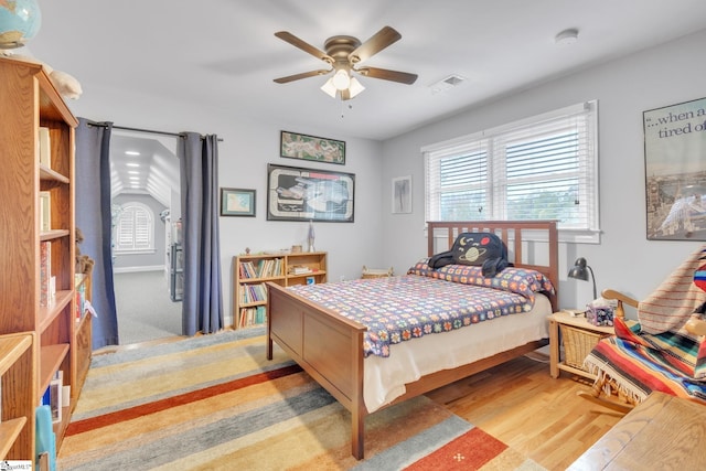 bedroom featuring vaulted ceiling, light hardwood / wood-style flooring, and ceiling fan