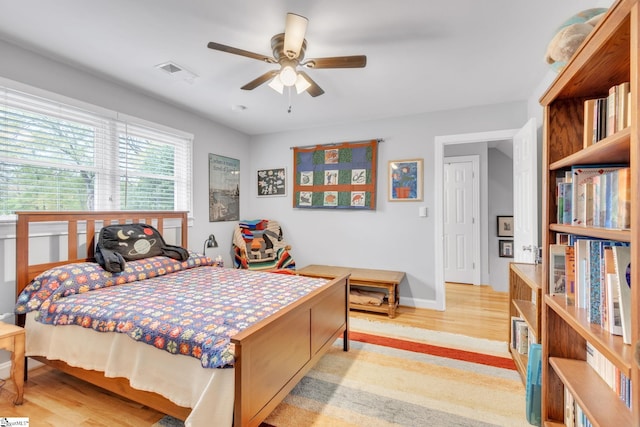 bedroom with ceiling fan and light wood-type flooring