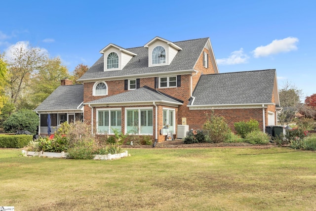 view of front of house with a front lawn and a sunroom