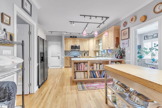 kitchen featuring tasteful backsplash, ornamental molding, stainless steel appliances, light brown cabinets, and light hardwood / wood-style floors