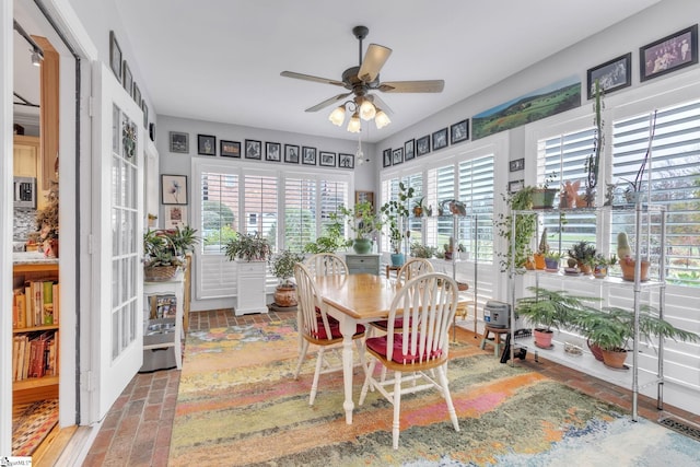 sunroom / solarium featuring a wealth of natural light and ceiling fan