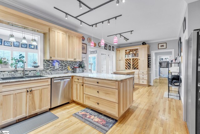 kitchen featuring dishwasher, light brown cabinetry, kitchen peninsula, and decorative light fixtures