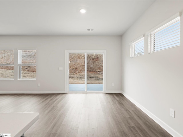 empty room with hardwood / wood-style flooring