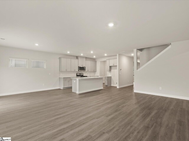 unfurnished living room featuring hardwood / wood-style flooring