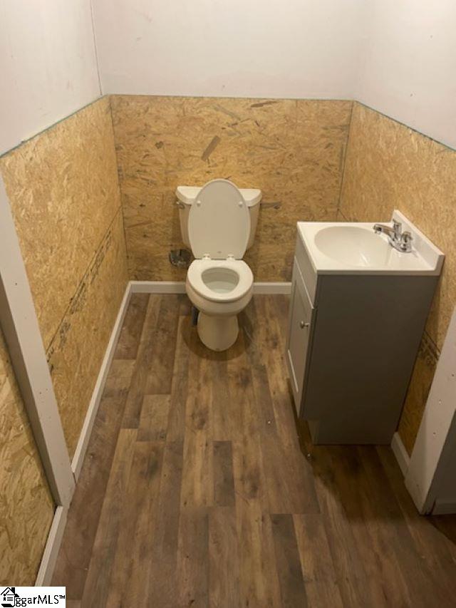 bathroom featuring hardwood / wood-style floors, vanity, and toilet