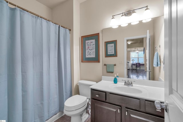 bathroom with tile patterned flooring, vanity, and toilet