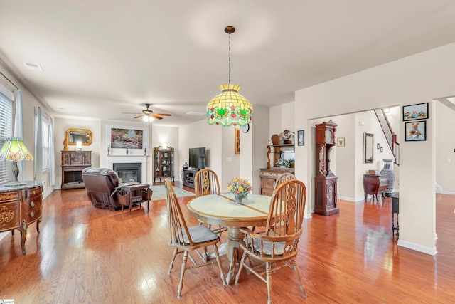 dining room featuring light hardwood / wood-style flooring and ceiling fan