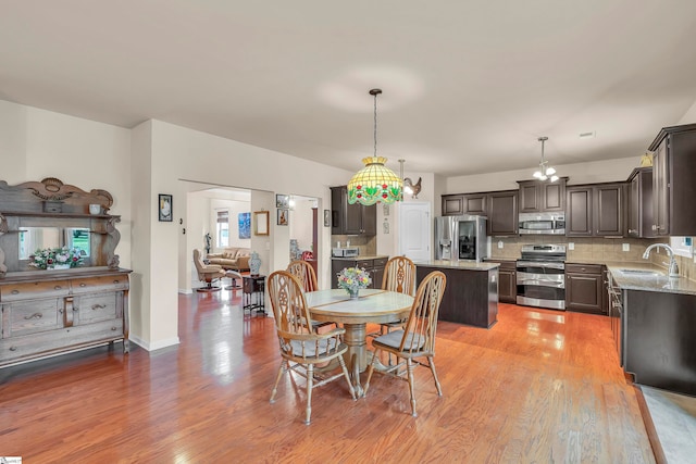 dining area featuring sink and light hardwood / wood-style floors