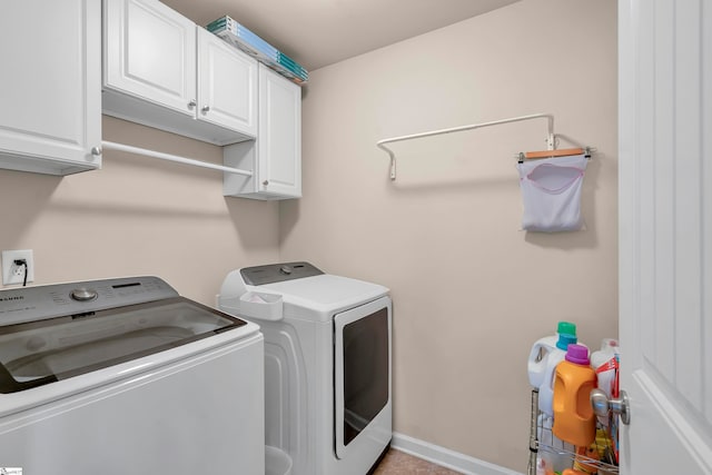 laundry room featuring cabinets and washer and dryer